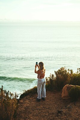 Buy stock photo Woman, mountain and phone for photography, travel and tropical holiday with social media on weekend. Female person, nature and back for live streaming, relax and vacation with mobile, view and memory