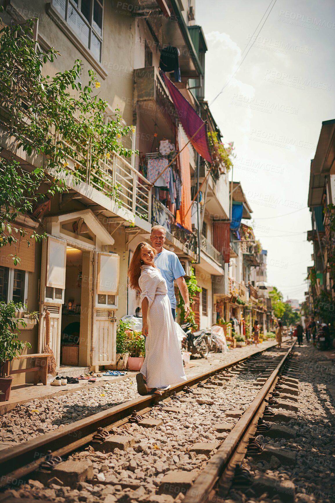 Buy stock photo Travel, couple and vacation portrait by railway for holiday adventure, romance and sightseeing Vietnam. Tourist, people and exploring destination for honeymoon and relationship getaway with bonding