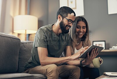 Buy stock photo Sofa, happy and couple with tablet in home for social media, website and online shopping. Relax, dating and man and woman on digital tech with coffee for internet, news and videos in living room