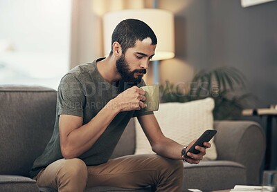 Buy stock photo Morning, phone and man on sofa with coffee for social media, online post and internet in home. Apartment, weekend and person with drink on smartphone for reading ebook, website news and connection