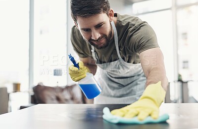 Buy stock photo Home, table and man with spray for cleaning, hygiene, disinfection for housework with smile. Apartment, male person and gloves for safety, surface bacteria and chores with liquid detergent for fabric