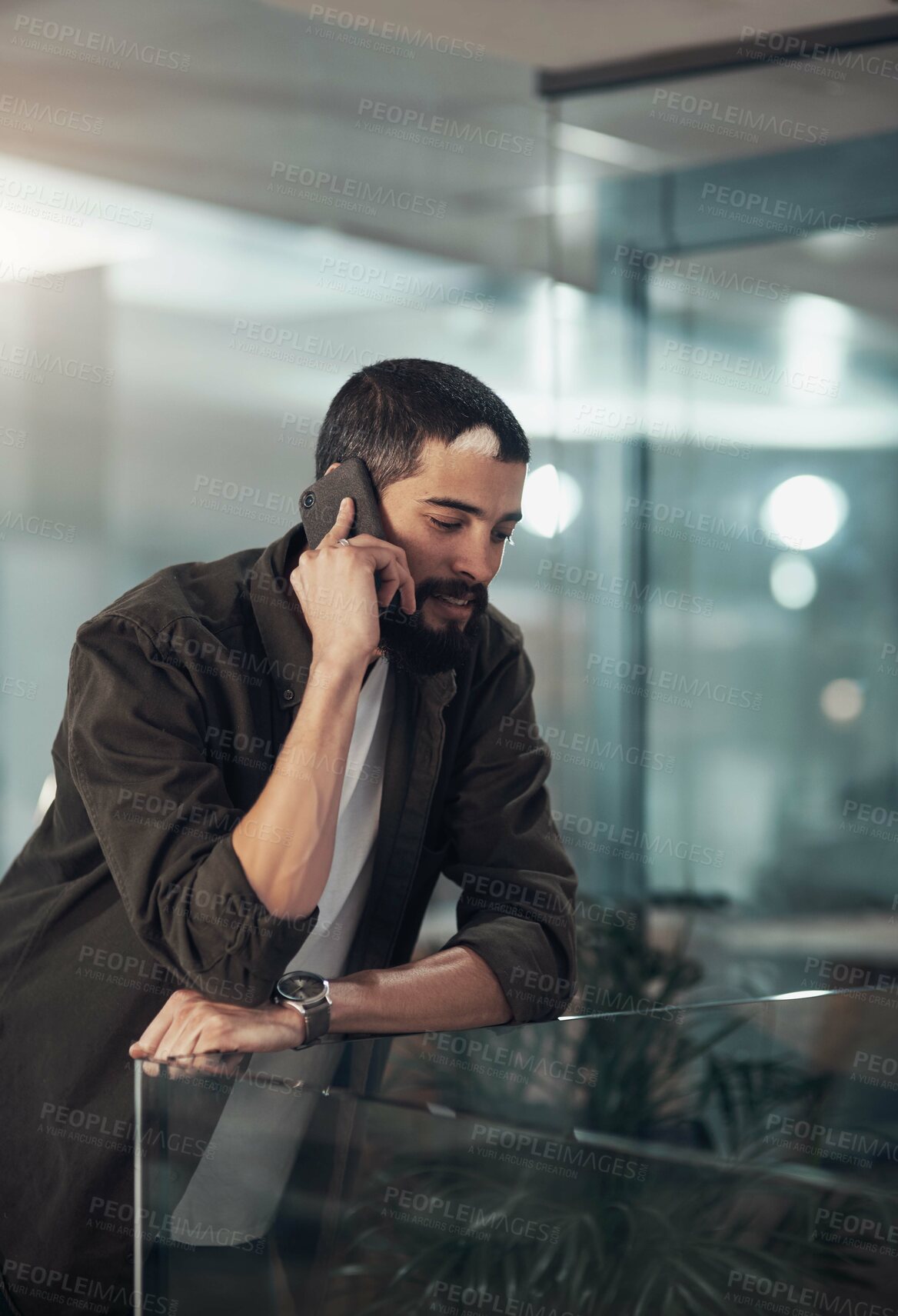 Buy stock photo Creative, designer and man with phone call in startup with client for feedback, project update and task. Night, overtime and male person on mobile communication for content approval,  and negotiation