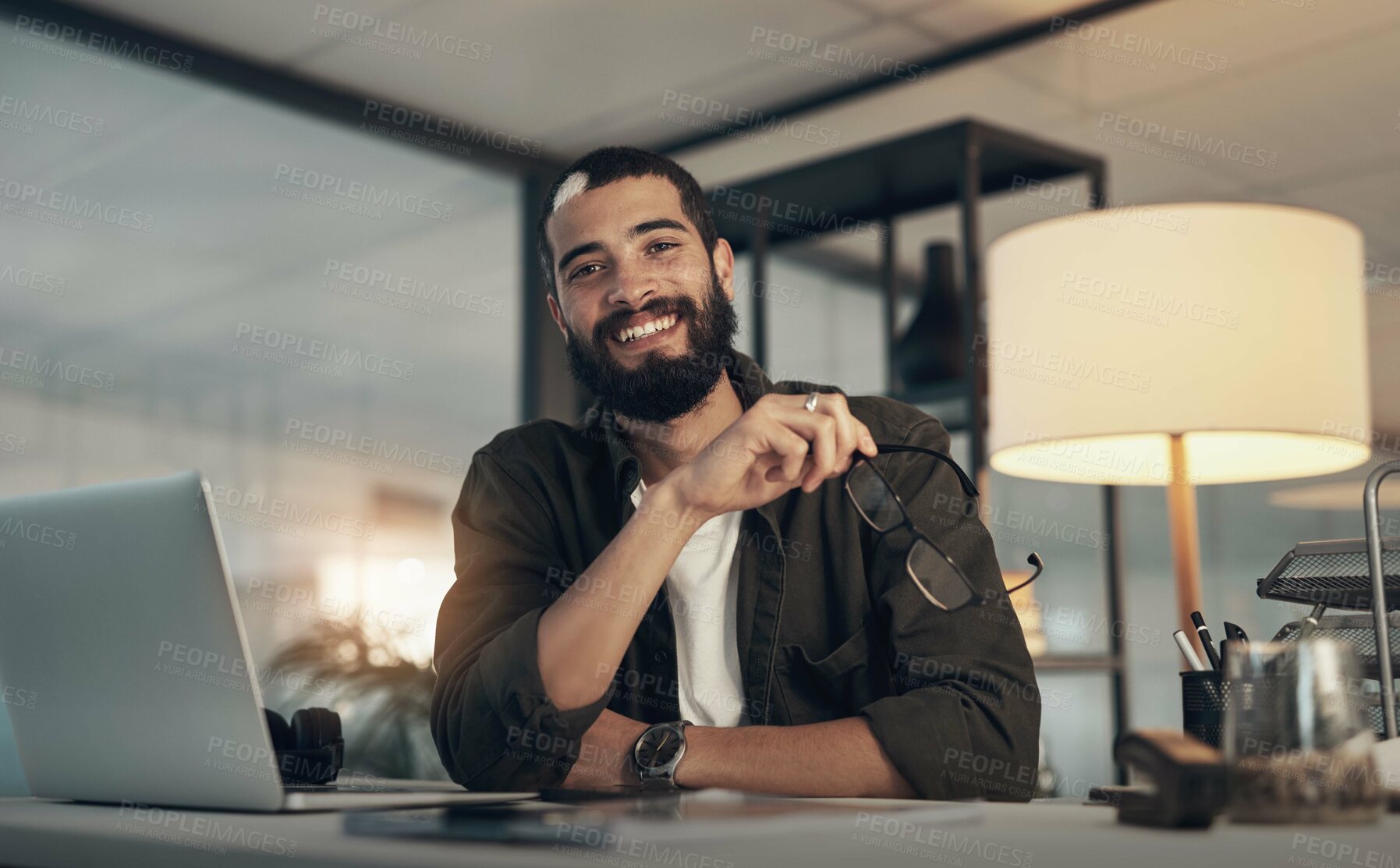 Buy stock photo Design, laptop and portrait of programmer man in office at night for coding or computer engineering. Creative, programming and smile with happy employee at desk in workplace for project deadline