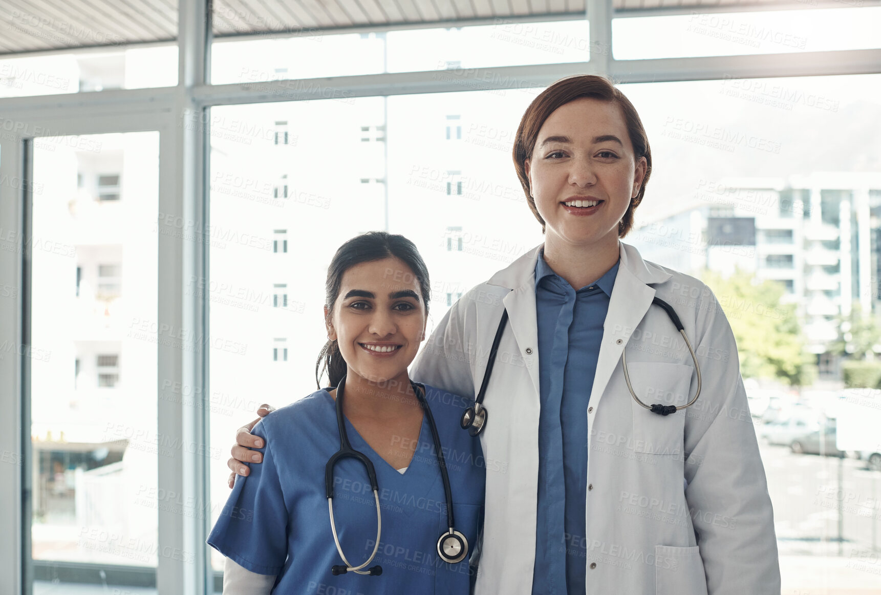 Buy stock photo Portrait, women and doctors in clinic, hug and confidence with pride, professional and cooperation. Face, people and medical with teamwork, nurse and mentor with intern, collaboration and hospital