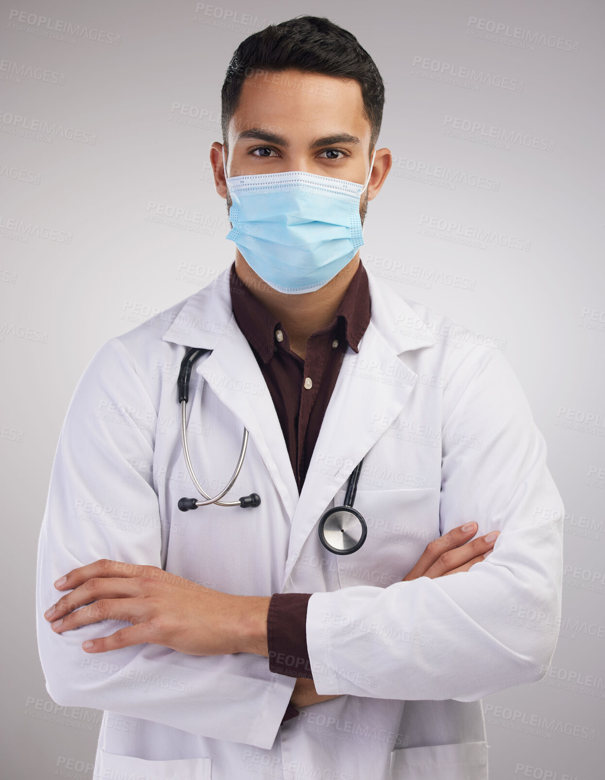 Buy stock photo Man, doctor and mask in studio with portrait for protection of bacteria, respiratory hygiene and infection control. Male medical worker, confident and face cover for airborne germ on white background