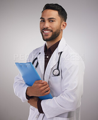Buy stock photo Portrait, happy and doctor with documents in studio for healthcare, medical and staff in lab coat by grey background. Professional male person, stethoscope and pride for wellness and career 