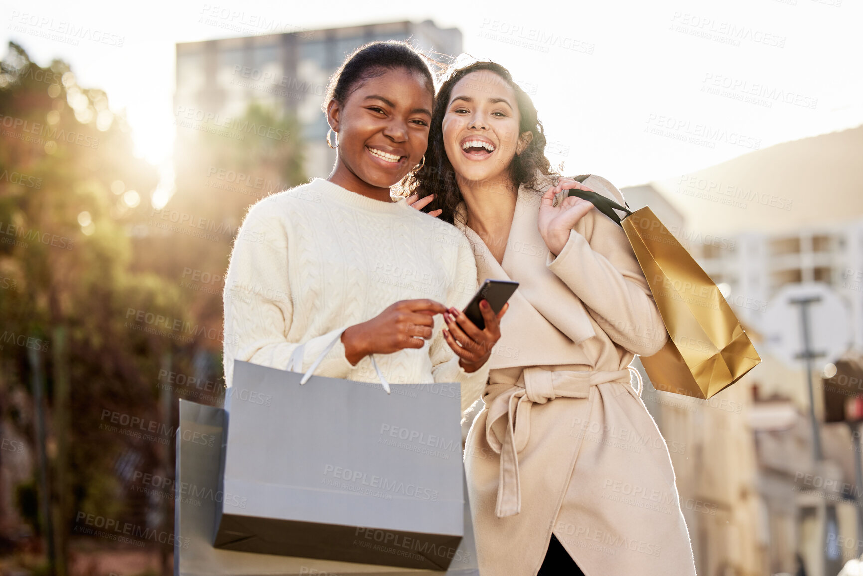 Buy stock photo Portrait, women and paper bag with smartphone for online shopping, sale or retail together outdoor by mall. Happy people, friends and cellphone for ecommerce, discount and deal for fashion or clothes