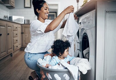 Buy stock photo Mother, infant and washing machine for laundry in home, helping mom and multitask with chores. Mama, support daughter and housekeeping with child in kitchen, cleaning and loading clothes in routine