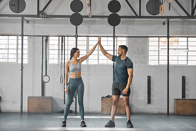 Buy stock photo Fit, active and healthy sports athletes training together in gym workout room, living a strong wellness lifestyle. Male and female fitness instructors high five and smiles in physical exercise class