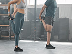 Fit, active and strong couple doing a warmup and stretching before a workout at the gym. Sporty boyfriend and girlfriend doing stretches to avoid injury, soreness and painful muscles during exercise