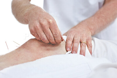 Buy stock photo An unrecognizable woman getting needles inserted into her knee during an acupuncture session. Closeup of patient getting alternative therapy for medical treatment