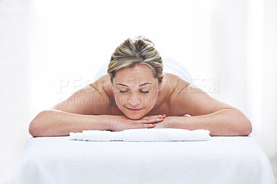 Buy stock photo A young woman getting needles inserted into her back during an acupuncture session. A patient getting alternative therapy for medical treatment