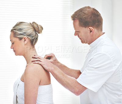 Buy stock photo A young woman getting needles inserted into her back during an acupuncture session. A patient getting alternative therapy for medical treatment