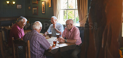Buy stock photo Group of senior men sitting together in a bar, bonding, senior friends enjoying a day in a pub