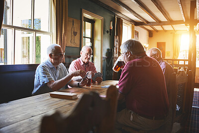Buy stock photo Group of senior men sitting together and playing card games in a bar, bonding, senior friends enjoying a game of bridge in a pub