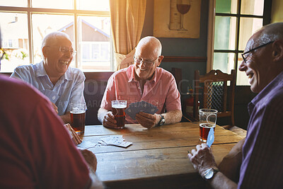 Buy stock photo Group of senior men sitting together and playing card games in a bar, bonding, senior friends enjoying a game of bridge in a pub