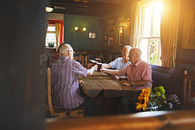 Buy stock photo Group of senior men sitting together and toasting with beer in a bar, bonding, senior friends enjoying a pint of beer in a pub, cheers