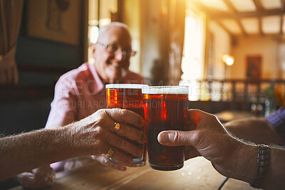 Buy stock photo Group of unknown senior men sitting together and toasting with beer in a bar, bonding, senior friends enjoying a pint of beer in a pub, cheers