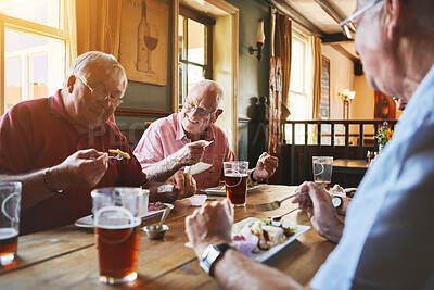 Buy stock photo Group of senior men sitting together and enjoying lunch in a pub, elderly friends bonding, eating lunch in a bar