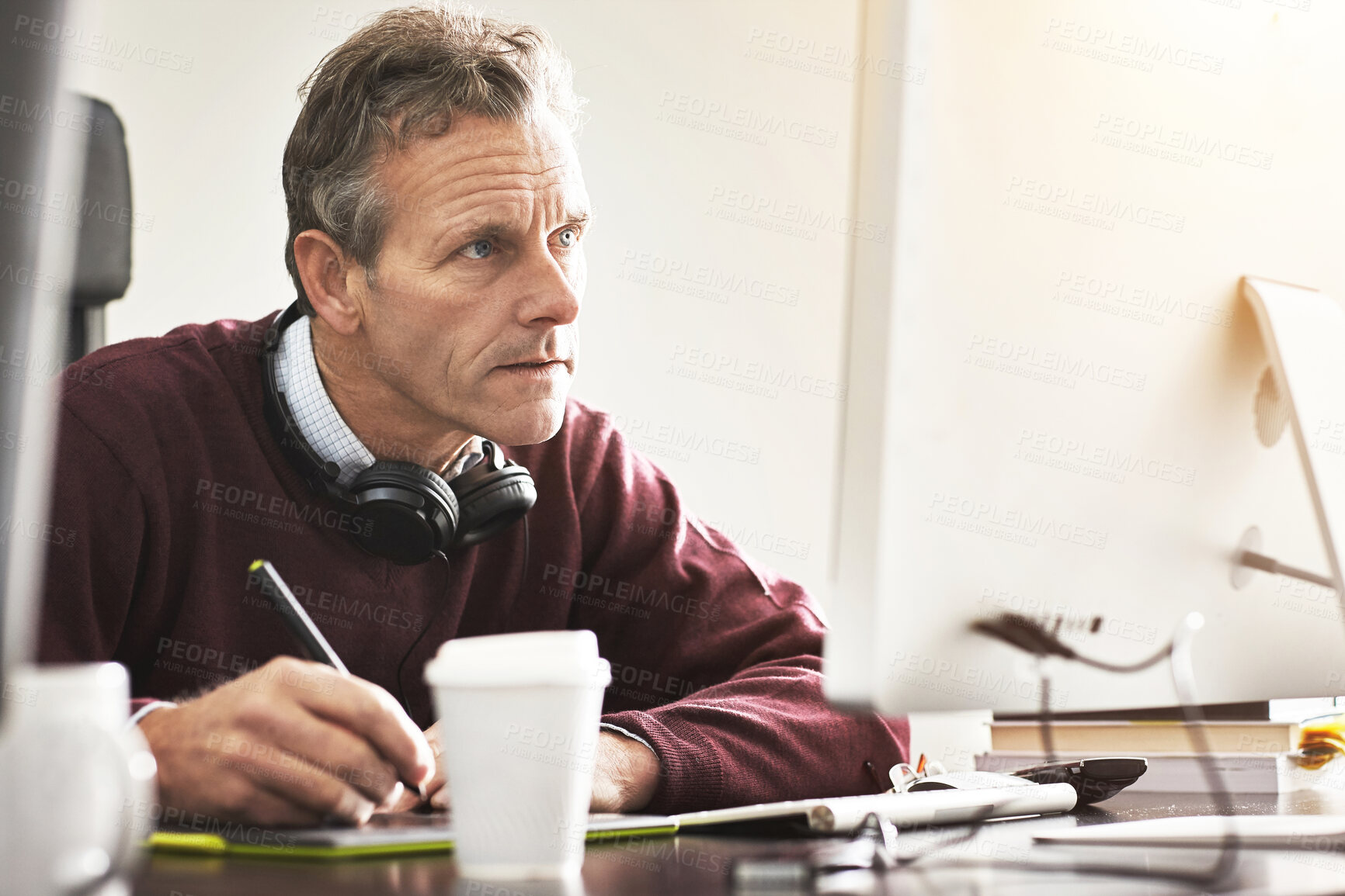 Buy stock photo A businessman using a digital tablet in a modern office. A mature male executive working online for business with a touchscreen