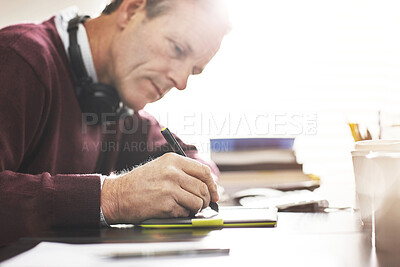 Buy stock photo A businessman using a digital tablet in a modern office. A mature male executive working online for business with a touchscreen