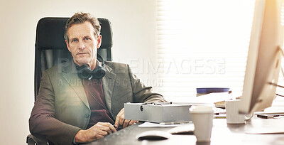 Buy stock photo Portrait of a mature businessman working in a modern office. A mature male executive sitting and working on his business at a desk