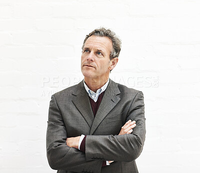 Buy stock photo A businessman thinking, isolated on a white background. A mature male executive looking thoughtful, planning business moves in an office or studio