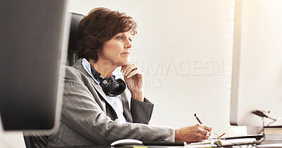 Buy stock photo A businesswoman using a computer in a modern office. A mature female executive working online for business at her desk