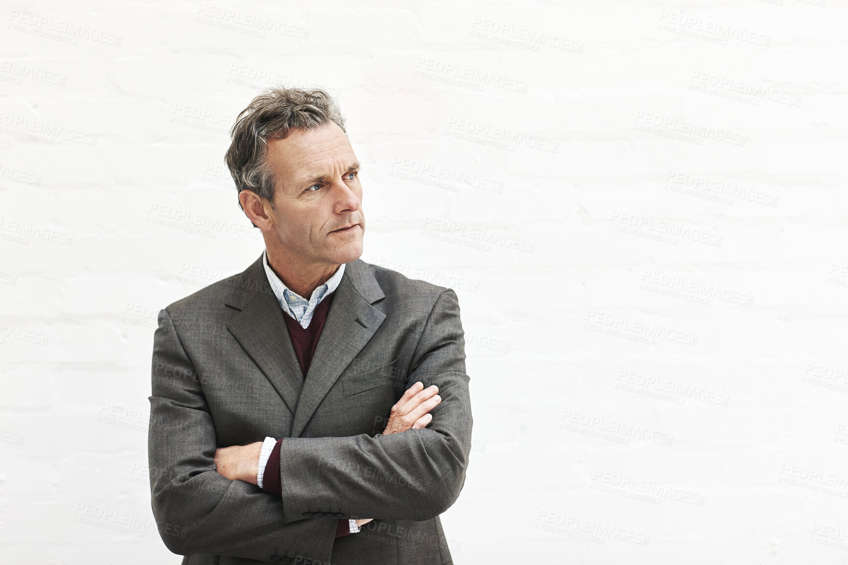 Buy stock photo A businessman thinking, isolated on a white background. A mature male executive looking thoughtful, planning business moves in an office or studio