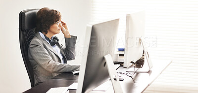 Buy stock photo A businesswoman using a computer in a modern office. A mature female executive working online for business at her desk