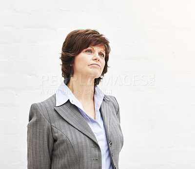 Buy stock photo A businesswoman thinking, isolated on a white background. A mature female executive looking thoughtful, planning business moves in an office or studio