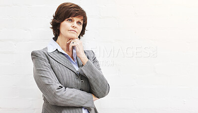 Buy stock photo A businesswoman thinking, isolated on a white background. A mature female executive looking thoughtful, planning business moves in an office or studio