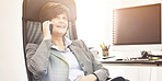 A businesswoman using a phone to make a call in a modern office. A mature female executive talking on her smartphone for business