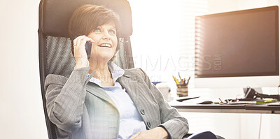 Buy stock photo A businesswoman using a phone to make a call in a modern office. A mature female executive talking on her smartphone for business
