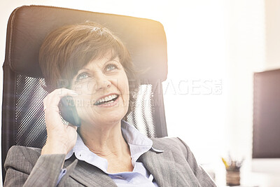 Buy stock photo A businesswoman using a phone to make a call in a modern office. A mature female executive talking on her smartphone for business