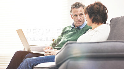 Buy stock photo A mature couple using a laptop, relaxing at home. A happy senior man and woman in love browsing online with a computer on the couch