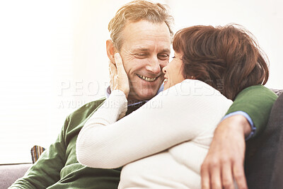 Buy stock photo A mature couple relaxing at home. A happy senior man and woman in love sharing a romantic moment on the couch