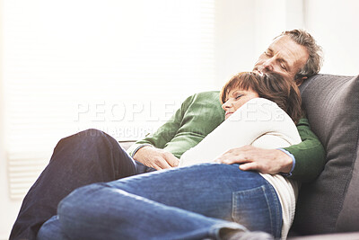 Buy stock photo A mature couple sleeping at home. A happy senior man and woman having a nap, sharing a comfortable moment on the couch