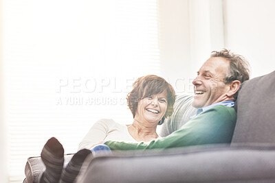 Buy stock photo A mature couple relaxing at home. A happy senior man and woman in love sharing a romantic moment on the couch