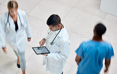 Buy stock photo Tablet, healthcare and medicine with a man doctor working in a busy hospital with urgency. Medical, research and insurance with professional workers in medicine rushing with blur in a clinic
