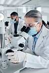 Innovation, covid and scientist woman with microscope and ppe for science research development or test in laboratory. Expert worker with biotechnology analysis studying sample for medical healthcare
