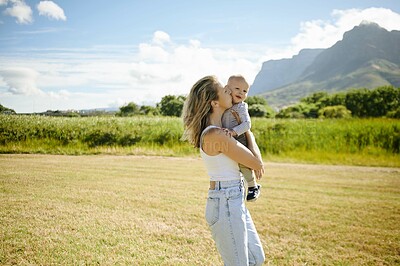 Buy stock photo Baby, kiss and mother walking in a field, happy and bonding in nature with love. Hug, kissing and woman with child in the countryside for fun, travel and vacation, walk and learning