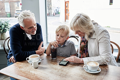 Buy stock photo Man, woman and boy with phone in coffee shop, drink and soda with click, relax and watch video. Grandparents, family and child with tea cup, online and smartphone with reading, press and cartoon