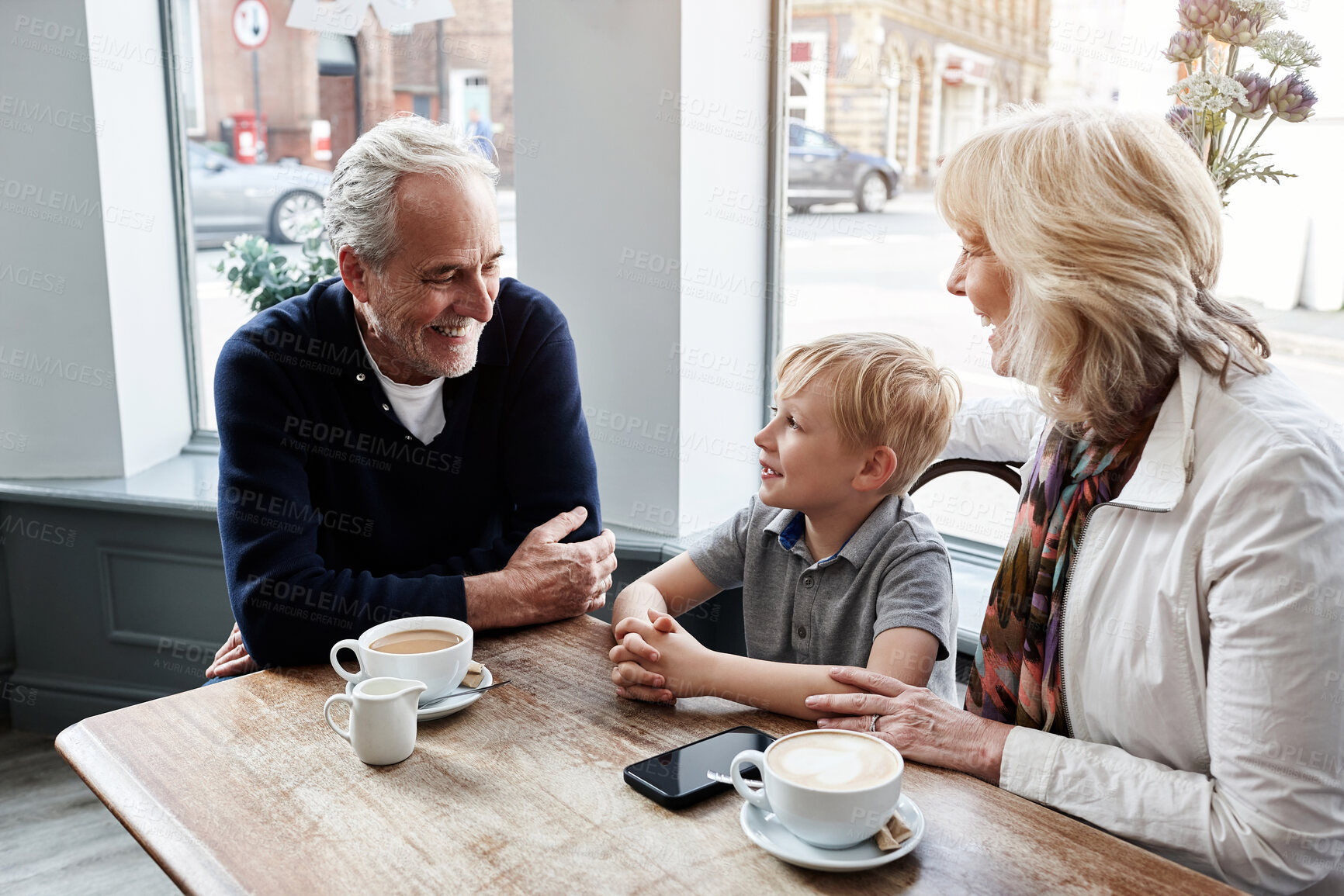 Buy stock photo Happy, family and grandparents with child at cafe for conversation, talking of holiday visit in London. Senior people with boy or kid at coffee shop for discussion, funny chat and planning at table