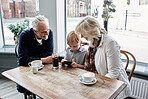 Family, child and coffee shop with phone, games and click with smile for soda, relax or watch video. Grandparents, family and child with tea cup, online and smartphone with reading, press and cartoon