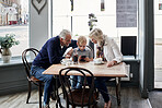 Family, grandparents and child with phone at cafe for online games, e learning and streaming video together. Senior people with boy child at coffee shop and mobile, chat or reading restaurant menu