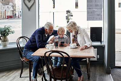 Buy stock photo Family, grandparents and child with phone at cafe for online games, e learning and streaming video together. Senior people with boy child at coffee shop and mobile, chat or reading restaurant menu