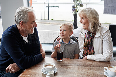 Buy stock photo Senior man, woman and child in coffee shop, drink and soda with funny talk, vacation and relax with care. Grandparents, family and boy with glass, tea cup and matcha with smile, laugh or conversation