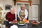 Kitchen, cooking and old couple with a tablet, smile and digital app with instructions, vegetables and internet. Home, elderly man and senior woman with technology, online recipe and healthy food