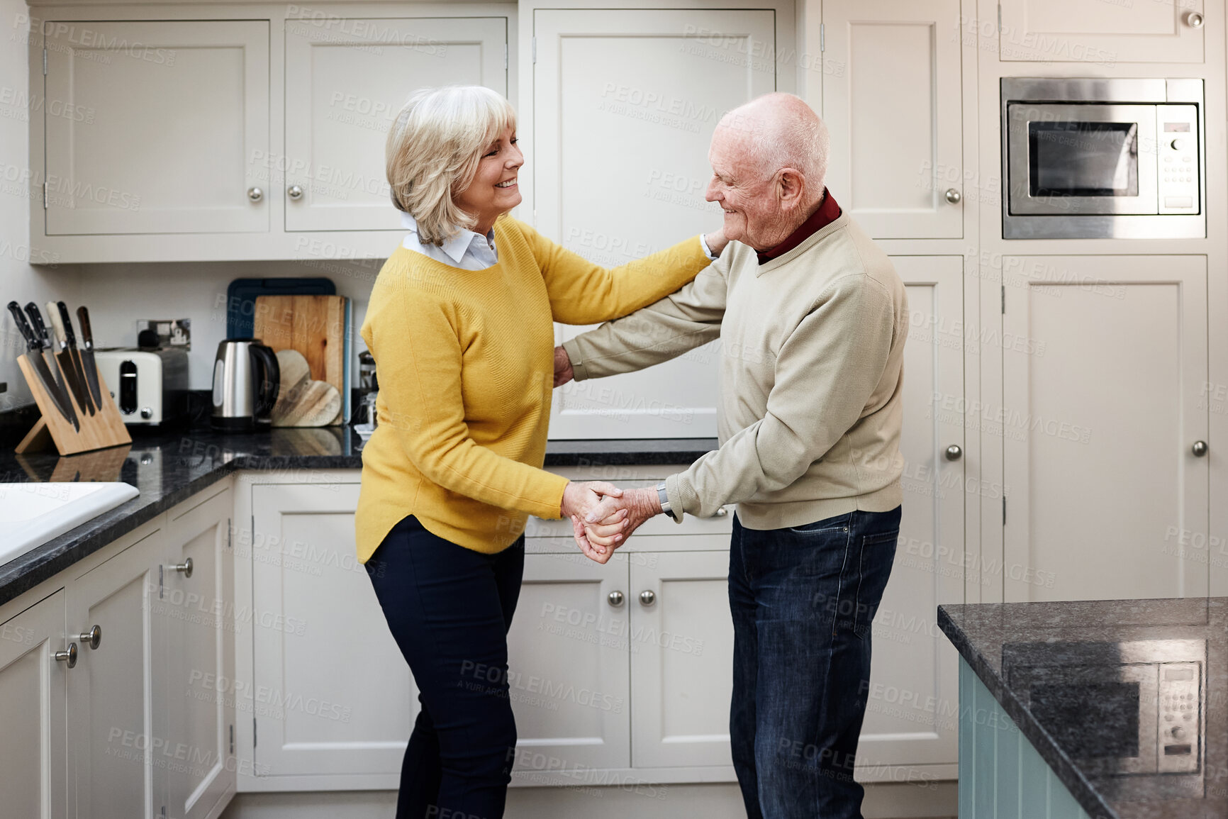 Buy stock photo Love, dance and senior couple on a kitchen with music, happy and bonding in their home. Retirement, celebration and old people dancing to radio, partner or fun with care, trust or support in a house